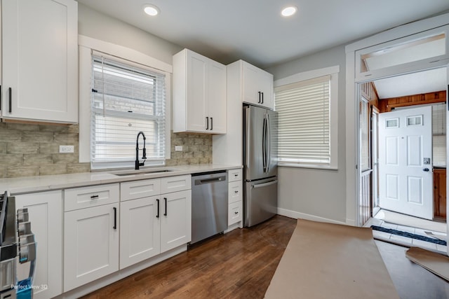5448 N Lieb Ave, Chicago, IL 60630 - kitchen with appliances with stainless steel finishes, a sink, baseboards, white cabinetry, and backsplash