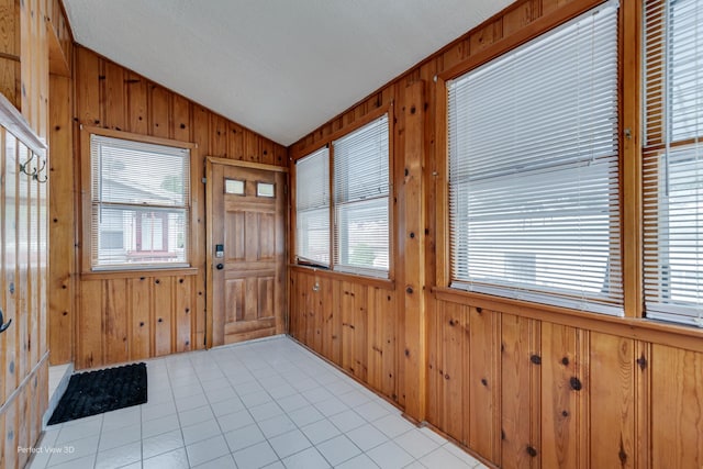 5448 N Lieb Ave, Chicago, IL 60630 - foyer with vaulted ceiling, wooden walls, healthy amount of natural light, and light tile patterned flooring