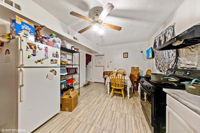 2625 S Drake Ave, Chicago, IL 60623 - kitchen featuring black stove, freestanding refrigerator, ceiling fan, light countertops, and custom exhaust hood