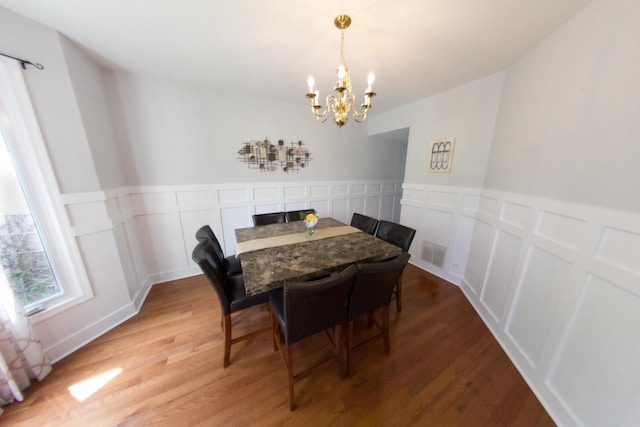 1034 Idaho St, Carol Stream, IL 60188 - dining room featuring a chandelier, light wood-style floors, a decorative wall, and wainscoting