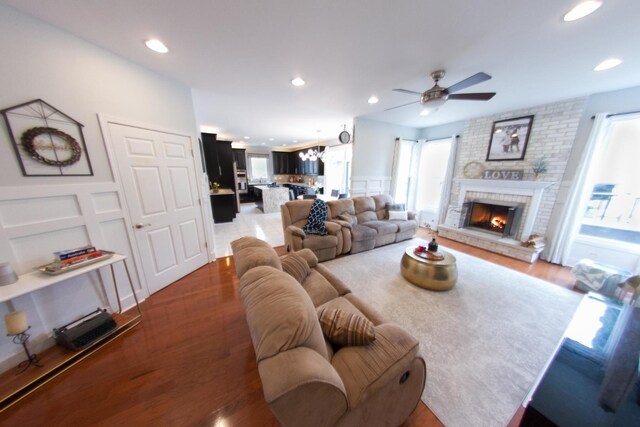 1034 Idaho St, Carol Stream, IL 60188 - living area with ceiling fan, wood finished floors, recessed lighting, a brick fireplace, and a decorative wall