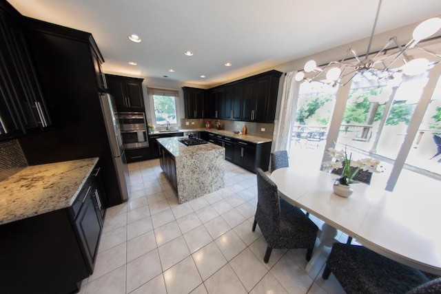 1034 Idaho St, Carol Stream, IL 60188 - kitchen featuring gas stovetop, double oven, a sink, dark cabinetry, and a chandelier