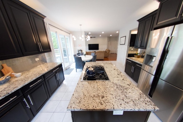 1034 Idaho St, Carol Stream, IL 60188 - kitchen featuring stainless steel fridge with ice dispenser, gas stovetop, a chandelier, open floor plan, and light stone counters