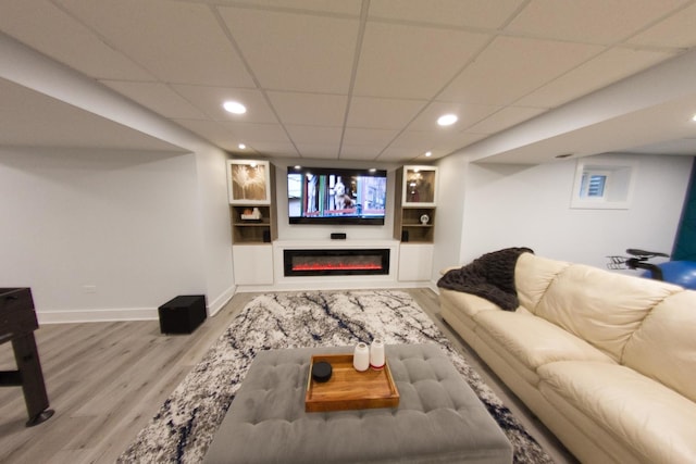 1034 Idaho St, Carol Stream, IL 60188 - living area featuring light wood-style floors, baseboards, recessed lighting, a drop ceiling, and a glass covered fireplace