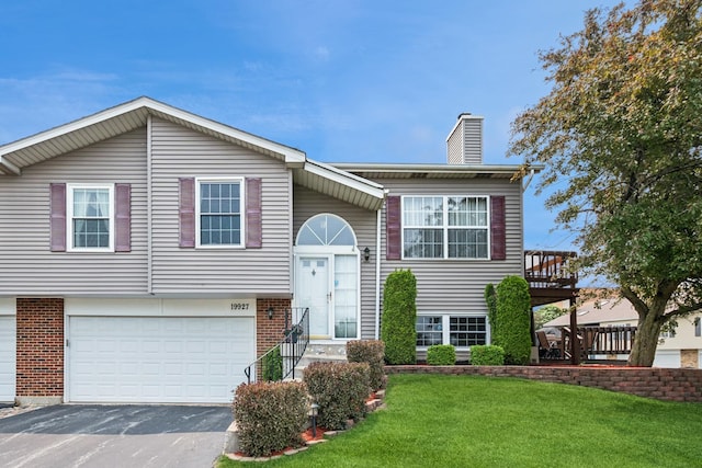 19927 S Edinburgh Ln Unit 0, Frankfort, IL 60423 - raised ranch with driveway, a garage, a front yard, a chimney, and brick siding
