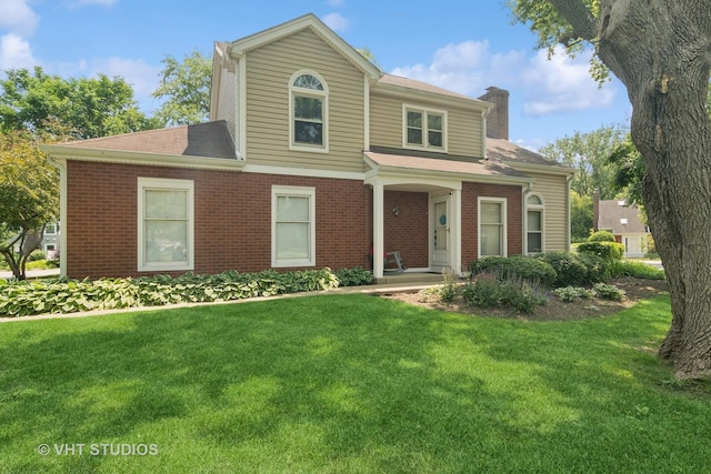 54 S Stonington Dr Unit 92, Palatine, IL 60074 - view of front of property featuring a chimney, brick siding, a front lawn, and roof with shingles