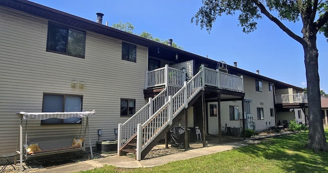 1804 Oliver Dr Unit 8, Urbana, IL 61802 - back of house featuring a lawn, a deck, stairs, and central AC
