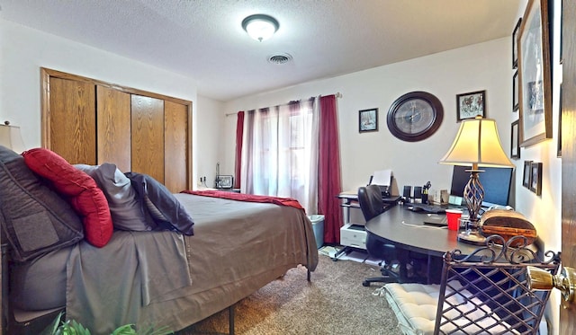 1804 Oliver Dr Unit 8, Urbana, IL 61802 - carpeted bedroom featuring a desk, a closet, and a textured ceiling