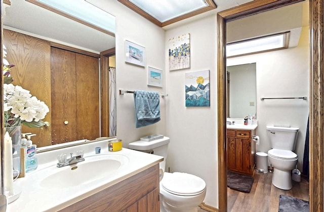 1804 Oliver Dr Unit 8, Urbana, IL 61802 - bathroom featuring toilet, vanity, and wood finished floors