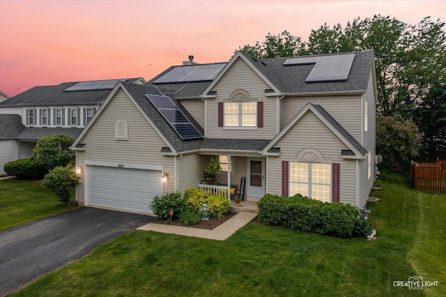 1889 Shore Line Ct, Romeoville, IL 60446 - traditional-style house with solar panels, a porch, a yard, and asphalt driveway