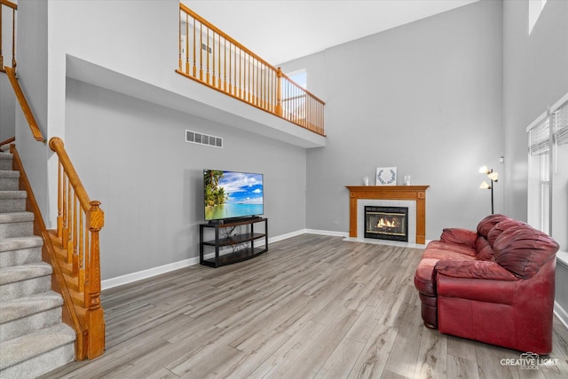 1889 Shore Line Ct, Romeoville, IL 60446 - living room with a towering ceiling, wood finished floors, stairway, and a tiled fireplace