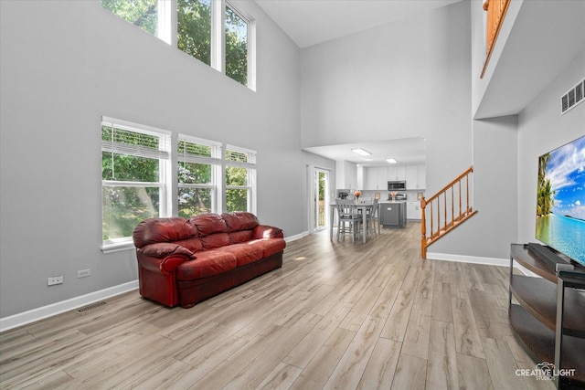 1889 Shore Line Ct, Romeoville, IL 60446 - living area with a high ceiling, light wood finished floors, and stairway