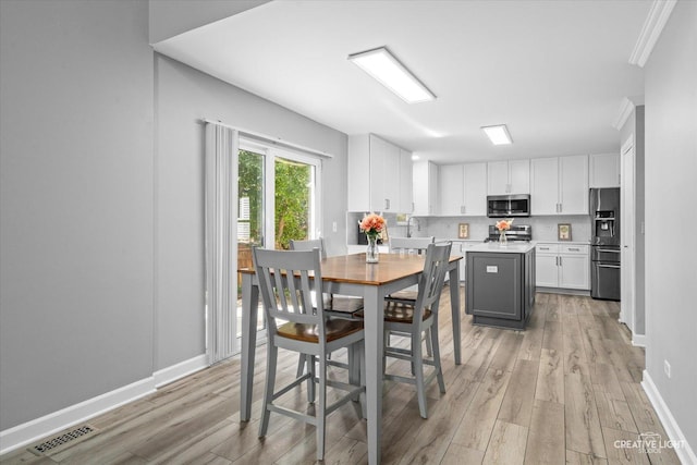 1889 Shore Line Ct, Romeoville, IL 60446 - dining room with light wood-type flooring and ornamental molding