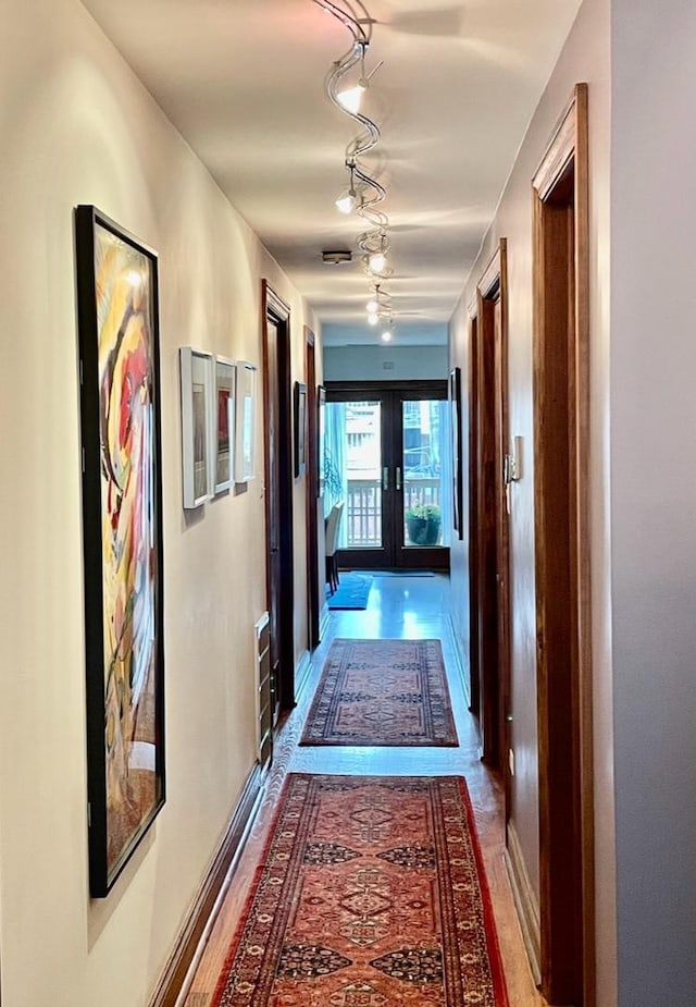 4413 N Malden St Unit 2S, Chicago, IL 60640 - corridor featuring french doors, rail lighting, and wood finished floors