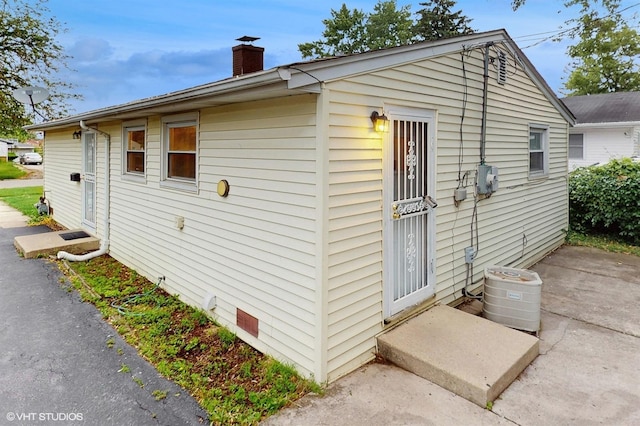 1917 W 163rd St, Markham, IL 60428 - view of side of home with a chimney and a central air condition unit