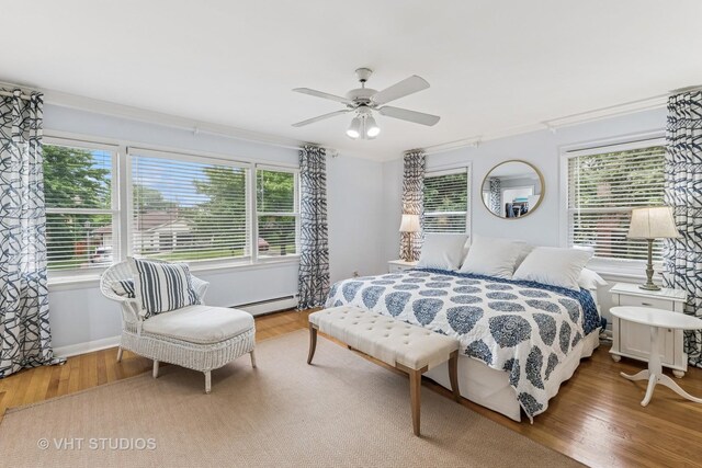 504 S Spring Ave, La Grange, IL 60525 - bedroom with a baseboard radiator, wood finished floors, crown molding, and ceiling fan