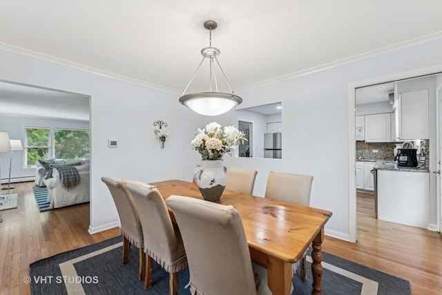 504 S Spring Ave, La Grange, IL 60525 - dining space featuring wood finished floors, ornamental molding, and a baseboard radiator