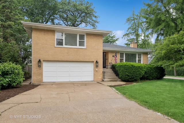 504 S Spring Ave, La Grange, IL 60525 - split level home featuring brick siding, a garage, a chimney, concrete driveway, and a front yard