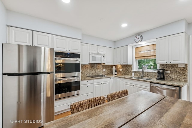 504 S Spring Ave, La Grange, IL 60525 - kitchen with appliances with stainless steel finishes, white cabinets, decorative backsplash, and recessed lighting
