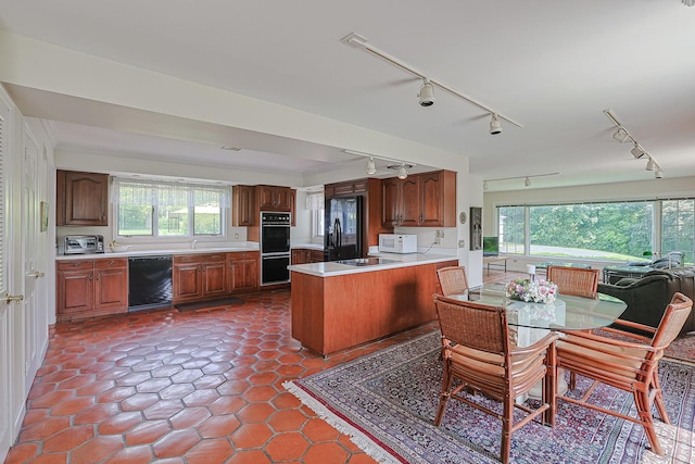 1596 W Palatine Rd, Inverness, IL 60067 - kitchen featuring black appliances, track lighting, light countertops, and a peninsula