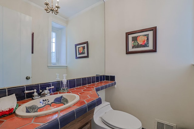 1596 W Palatine Rd, Inverness, IL 60067 - bathroom featuring crown molding, vanity, and a chandelier
