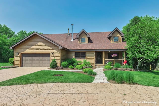 3619 Overlook Dr, Richmond, IL 60071 - view of front of property with a porch, a front lawn, driveway, an attached garage, and a shingled roof
