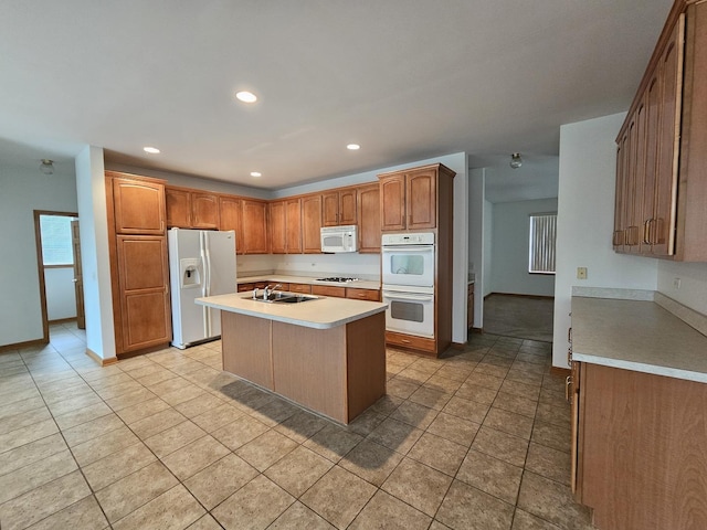 2 Kenilworth Ct, Cary, IL 60013 - kitchen featuring white appliances, light tile patterned floors, light countertops, a kitchen island with sink, and recessed lighting