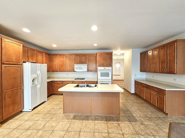 2 Kenilworth Ct, Cary, IL 60013 - kitchen featuring white appliances, light countertops, an island with sink, recessed lighting, and light tile patterned flooring