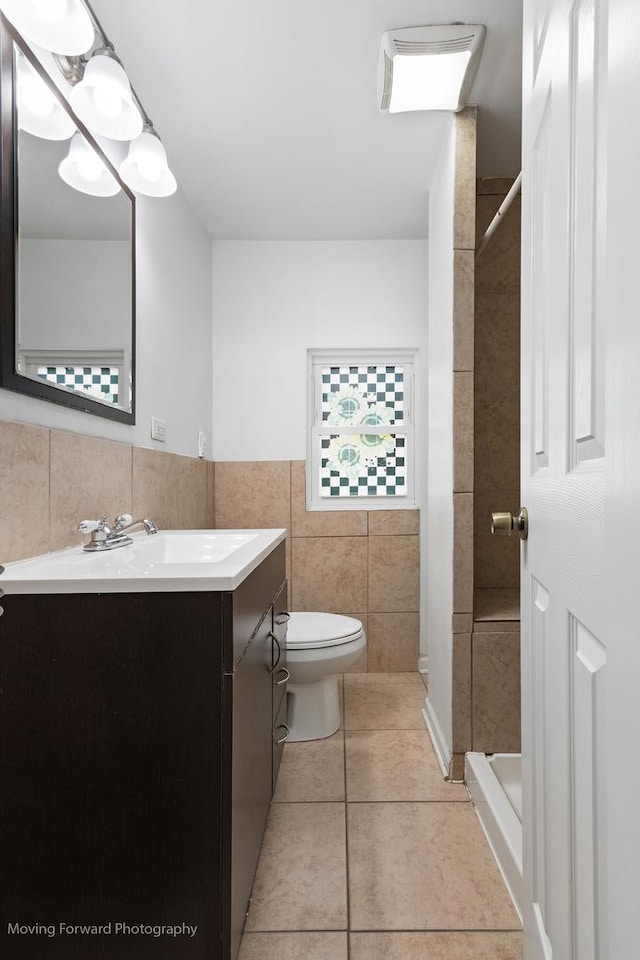 7324 W 56th Pl, Summit, IL 60501 - bathroom featuring tile walls, vanity, a shower, and tile patterned floors