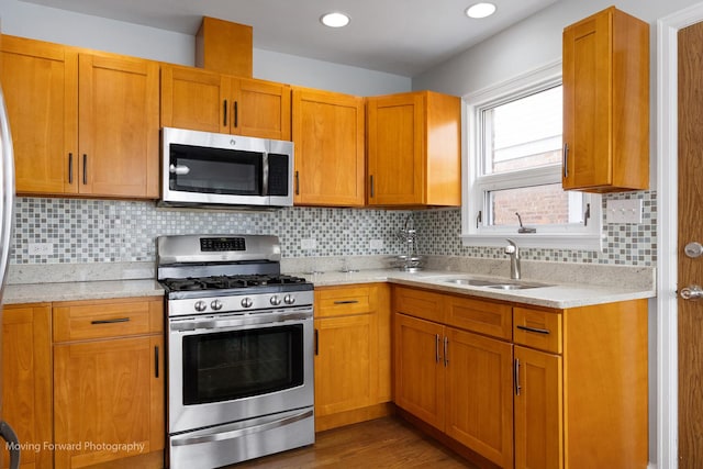 7324 W 56th Pl, Summit, IL 60501 - kitchen with appliances with stainless steel finishes, wood finished floors, tasteful backsplash, light stone countertops, and recessed lighting