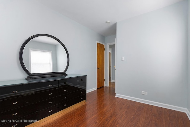 7324 W 56th Pl, Summit, IL 60501 - unfurnished bedroom with wood finished floors and baseboards