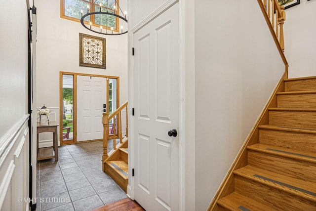 436 Kelly Ln, Crystal Lake, IL 60012 - foyer entrance featuring a chandelier, stairway, a high ceiling, and light tile patterned floors