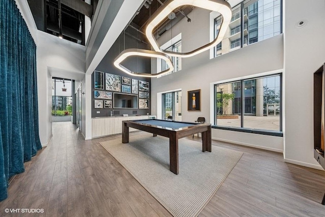 450 E Waterside Dr Unit 906, Chicago, IL 60601 - rec room with a towering ceiling, billiards, wood finished floors, and baseboards