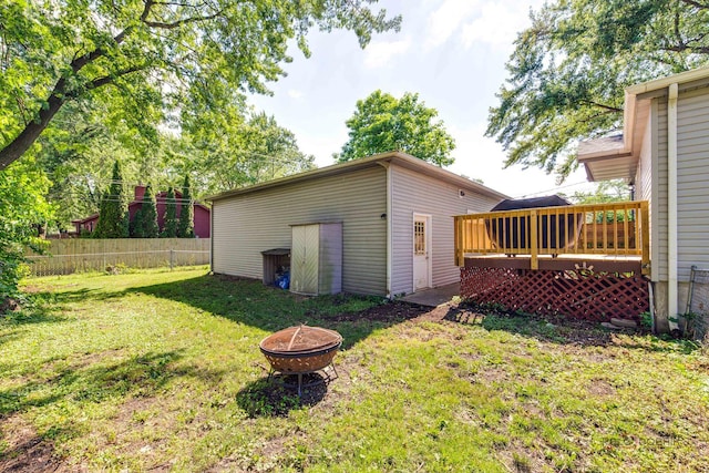 4519 W Shore Dr, Mchenry, IL 60050 - back of property featuring a fire pit, a wooden deck, and an outbuilding