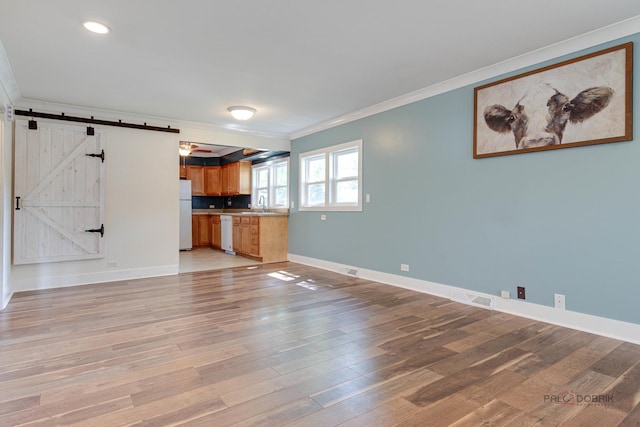 4519 W Shore Dr, Mchenry, IL 60050 - unfurnished living room with ornamental molding, a barn door, light wood-style flooring, and recessed lighting