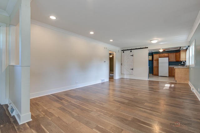 4519 W Shore Dr, Mchenry, IL 60050 - unfurnished living room with a barn door, crown molding, wood finished floors, and recessed lighting