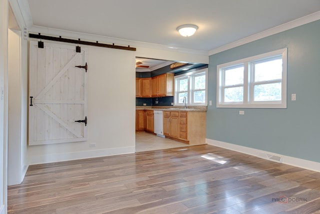 4519 W Shore Dr, Mchenry, IL 60050 - kitchen featuring white dishwasher, crown molding, light wood-style floors, a barn door, and light countertops