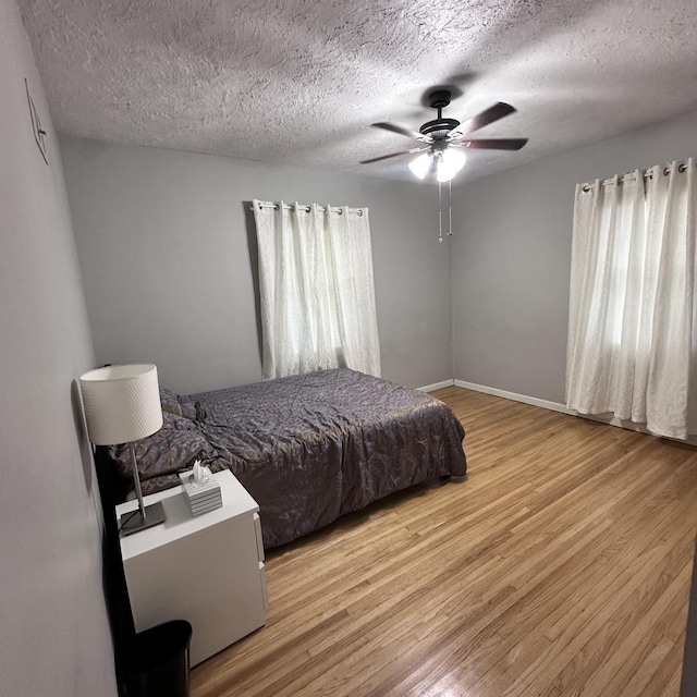 963 Oneida St, Joliet, IL 60435 - bedroom with light wood-style floors, a textured ceiling, and ceiling fan