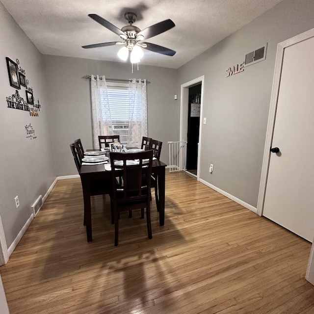 963 Oneida St, Joliet, IL 60435 - dining room featuring wood finished floors, a ceiling fan, cooling unit, and a textured ceiling