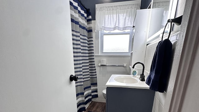 963 Oneida St, Joliet, IL 60435 - bathroom featuring vanity, tile walls, wood finished floors, a shower with curtain, and wainscoting