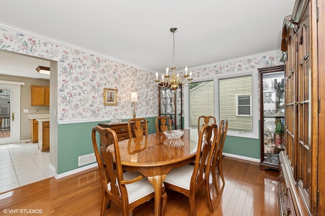 1370 Glacier Pkwy, Algonquin, IL 60102 - dining room with a chandelier, wainscoting, light wood finished floors, ornamental molding, and wallpapered walls