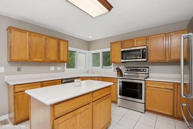 1370 Glacier Pkwy, Algonquin, IL 60102 - kitchen with stainless steel appliances, a sink, light countertops, light tile patterned floors, and a kitchen island