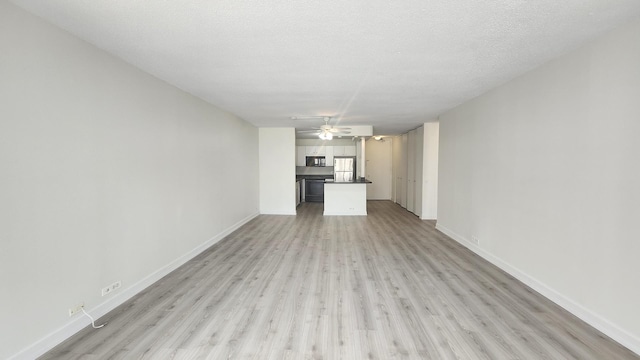 405 N Wabash Ave Unit 102, Chicago, IL 60611 - unfurnished living room with a ceiling fan, light wood-style flooring, baseboards, and a textured ceiling