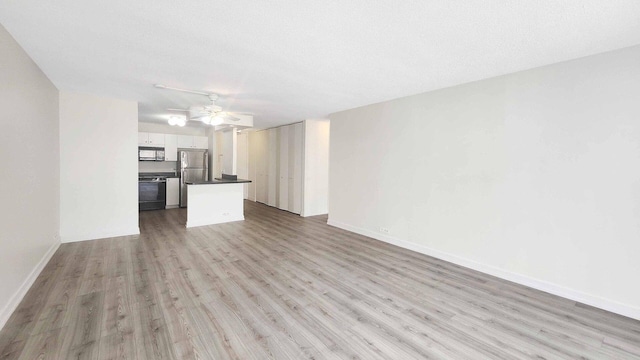 405 N Wabash Ave Unit 102, Chicago, IL 60611 - unfurnished living room featuring light wood-style floors and ceiling fan