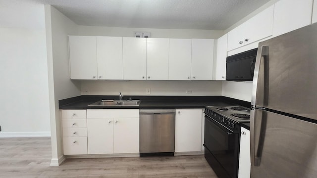 405 N Wabash Ave Unit 102, Chicago, IL 60611 - kitchen with stainless steel appliances, a sink, light wood finished floors, and white cabinets