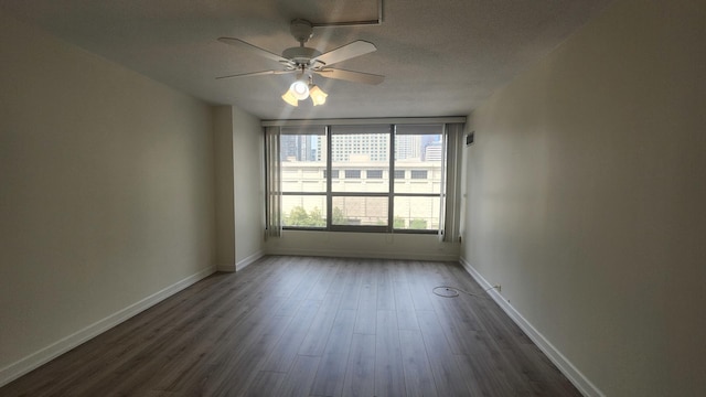 405 N Wabash Ave Unit 102, Chicago, IL 60611 - spare room with ceiling fan, dark wood-type flooring, baseboards, and a textured ceiling
