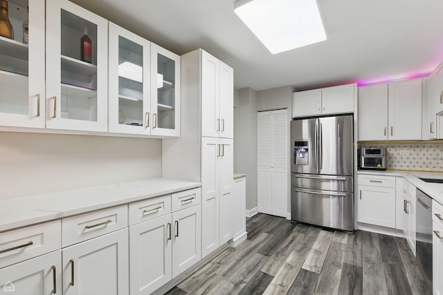 421 Pintail Ln, Deerfield, IL 60015 - kitchen featuring stainless steel appliances, white cabinets, decorative backsplash, dark wood-style flooring, and glass insert cabinets