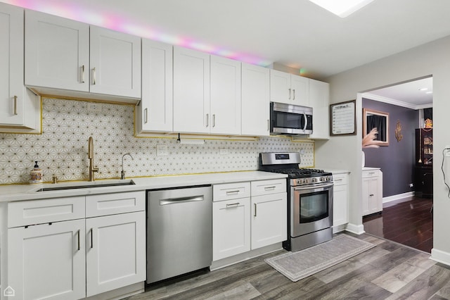 421 Pintail Ln, Deerfield, IL 60015 - kitchen with appliances with stainless steel finishes, a sink, light countertops, decorative backsplash, and ornamental molding
