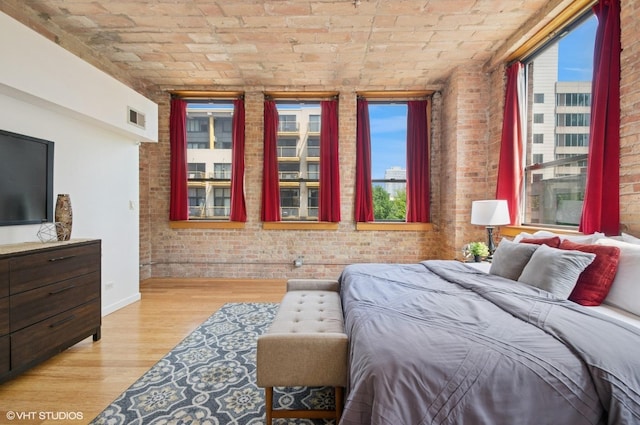 120 E Cullerton St Unit 402, Chicago, IL 60616 - bedroom with brick wall, multiple windows, brick ceiling, and light wood-style flooring