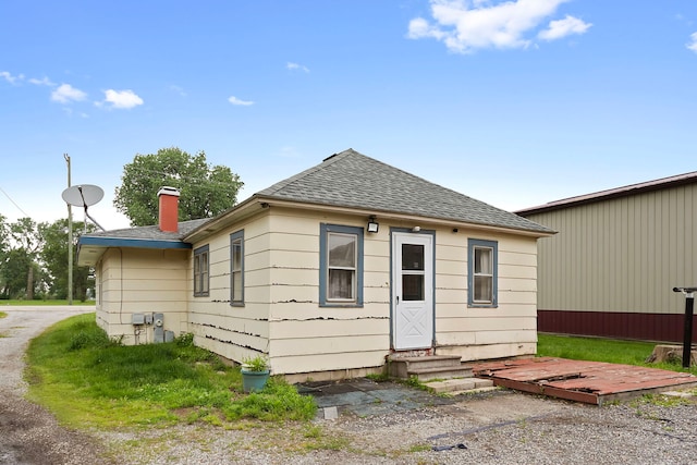 5460B W State Route 17, Kankakee, IL 60901 - rear view of house featuring a shingled roof, a chimney, and entry steps